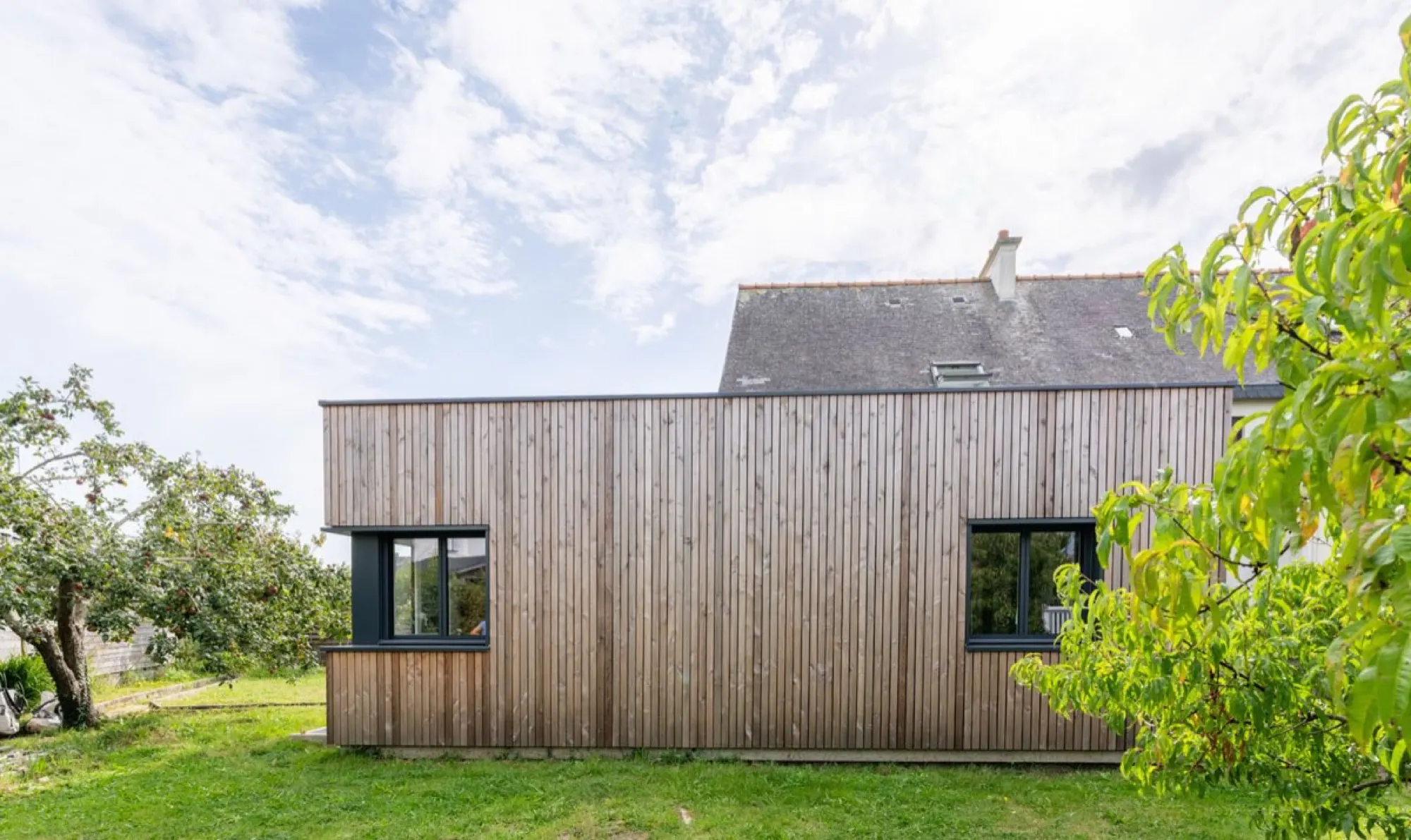 Extension contemporaine en bardage bois sur une maison bretonne